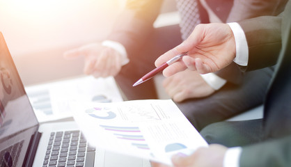 Business team hands at work with financial reports