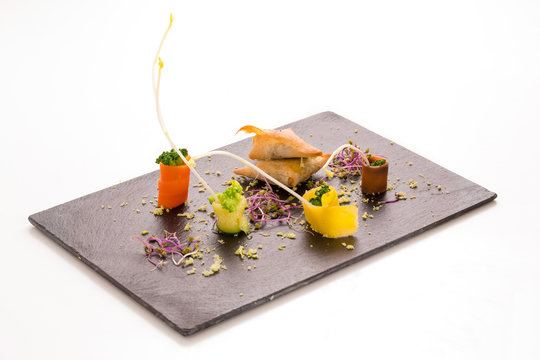 Slate tray with samousas and vegetables presented in roll