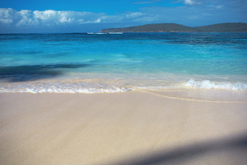sea surf, blue clear water and white sand