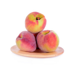 Peach in wood plate isolated on a white background