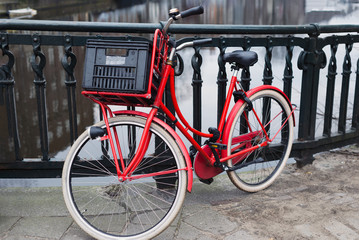 Fototapeta na wymiar Red bike on brdge over gracht canal, Amtserdam, London