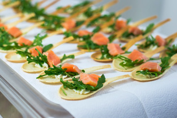 Delicates, appetizer filling with red fish and greens. Catring service.