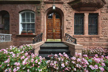 A view of a historic brownstone on a sunny summer day in an iconic neighborhood of Manhattan, New...