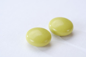 Green pills and tablets isolated on white background