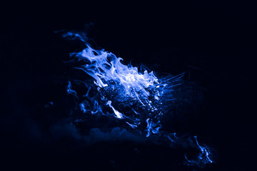 Blue flame. Burning of rice straw at night.