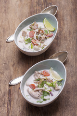 thai tom kha gai soup on wood