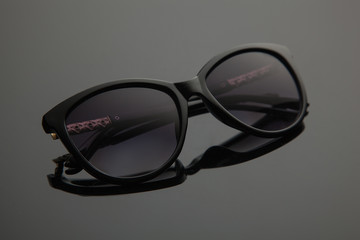 Fashion women sunglasses, black plastic, gold decoration on the douche, stylish gradient with...