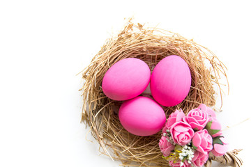 Fototapeta na wymiar Pink colored Easter eggs in nest on wooden background, selective focus image. Happy Easter card 