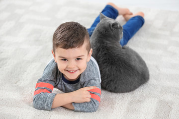 Cute little child with cat at home