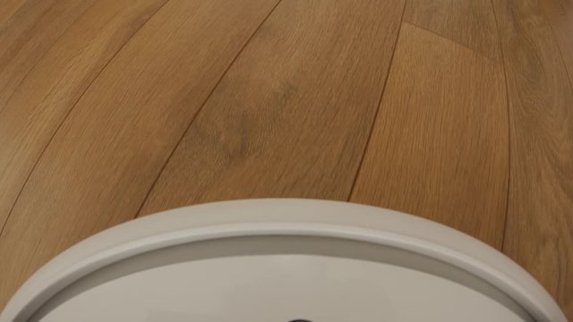 Robot vacuum cleaner on floor, Smart robotic automate wireless cleaning technology machine. Camera mounted directly on the Sweeper.