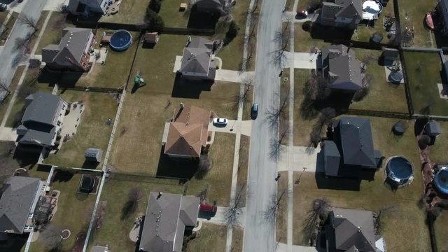 Overhead aerial view of residential houses and yards along suburban street - Travel and leisure concept