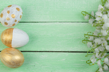 Happy Easter. Painted eggs on wooden table. Top view. Copy space for text.
