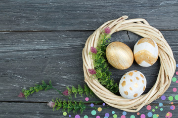 Happy Easter. eggs on wooden table background.. Balls, wreath woven from the vines. Copy space for text. Top view.