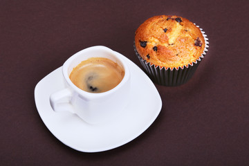 Homemade muffin with raisins and cup classic espresso coffee. selective focus.