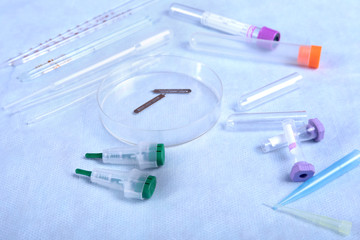 Set of laboratory supplies for blood test. Petri dish, Spectrophotometer cuvettes, blood test-tube. Selective focus.
