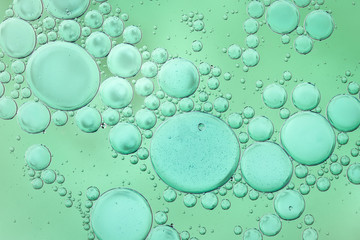 Large and small green bubbles on green background
