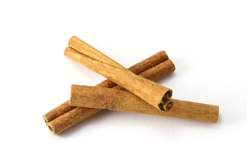 Top view of cinnamon sticks isolated on white.