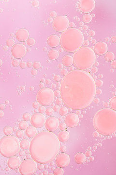 Large and small pink bubbles on pink background