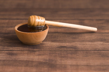 Honey with a Honey Spoon in a Small Wooden Bowl