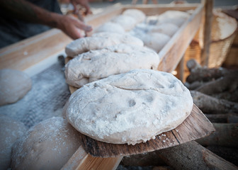 Bread dough in the foreground with bakery background.