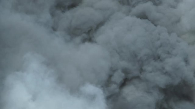 Thick smoke fills frame from huge fire burning, great texture or background.