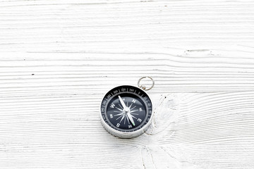 Fototapeta na wymiar Direction concept with compass on white wooden background top view mockup