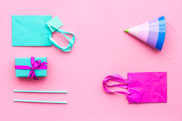 Gift box and colorful paper bag on pink background top view mock-up