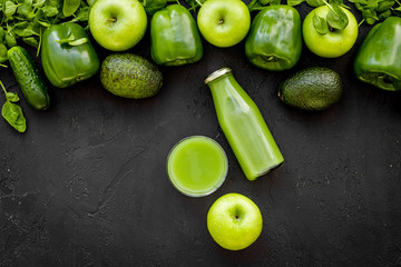Fototapeta na wymiar Fitness greeny drink with vegetables on dark background top view mock-up