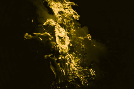 Yellow flame. Burning of rice straw at night.