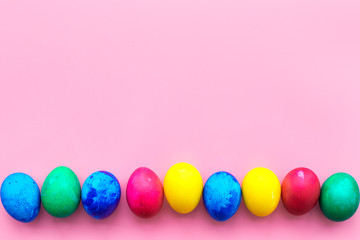 Colorful easter eggs on plate background top view mockup
