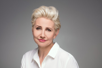 Portrait of elegant blonde middle aged woman.