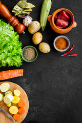 Diet vegetarian vegan food. Ratatouille or vegetable ragout. Black table background top view space for text