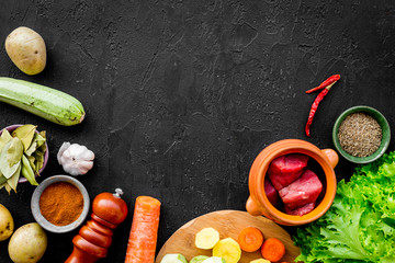 Diet vegetarian vegan food. Ratatouille or vegetable ragout. Black table background top view space...