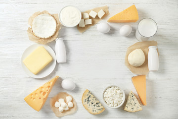 Fresh dairy products and eggs on wooden background