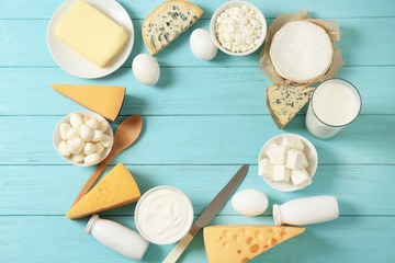 Fresh dairy products and eggs on wooden background