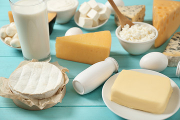 Fresh dairy products and eggs on wooden background