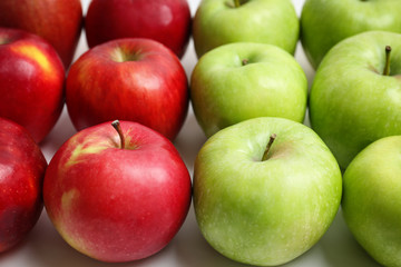 Fresh green and red apples on white background, closeup