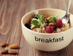 Oatmeal with fresh berries and nuts close up