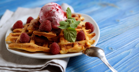 Waffles with raspberry ice cream and fresh raspberries, decorate