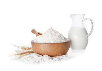Fototapeta na wymiar Wheat flour and jug of milk on white background