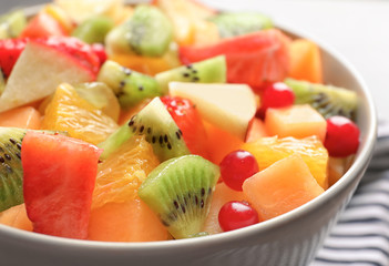 Bowl with fresh cut fruits, closeup