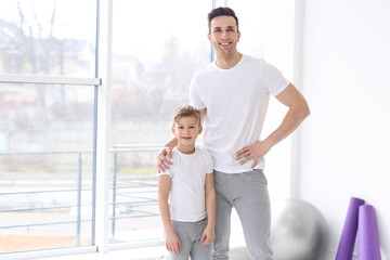 Fototapeta premium Dad and his son in gym