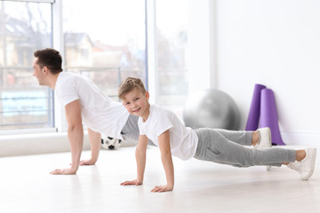 Dad and his son training in gym