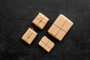 Courier workplace with cardboard box for delivery on black background top view mockup