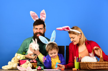 Rabbit's family with bunny ears. Egg surprise toys.