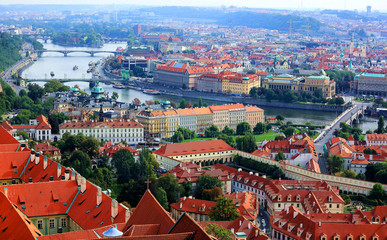 Naklejka premium Aerial panorama of Prague Old Town with houses of red roofs and bridges over Vltava River ~ Scenery of Prague Old Town, the capital of Czech Republic and a beautiful UNESCO heritage city