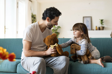Father playing with his daughter in a living room