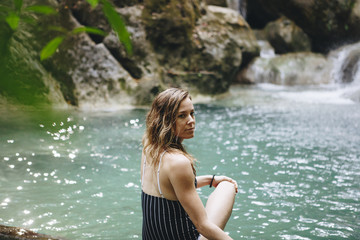 White woman enjoying the waterfall