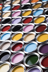 Buckets full of rainbow colored oil paint