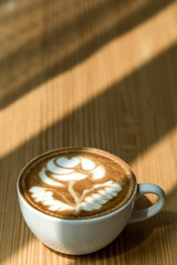 Top view of Hot Latte coffee with sun light